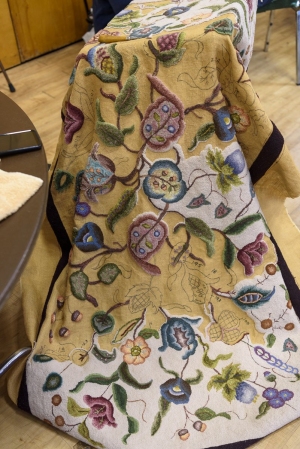 Alma Duseault hooking a rug started by Jeannie Zook