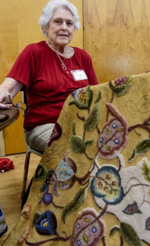 Alma Duseault hooking a rug started by Jeannie Zook