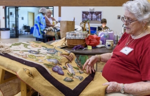 Alma Duseault hooking a rug started by Jeannie Zook