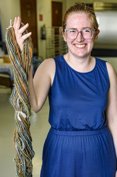 The young spinner shows off her successful skein.