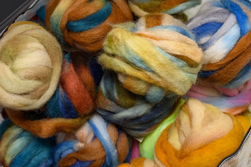 Colored balls of wool roving ready to spin.