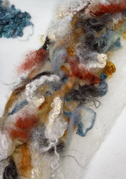 Colored roving on a white batt.