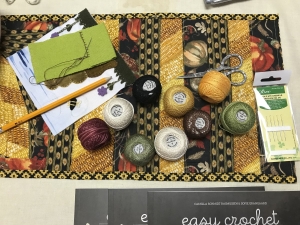 On the worktable, embroidery projects in progress.