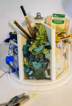 Embroidery floss, paintbrushes and pens.