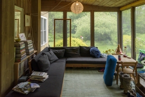 This screened-in sitting room was filled with books on home remodeling, embellishments, cool ideas, and Maine artists and people.