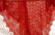 Red knitted lace shawl.