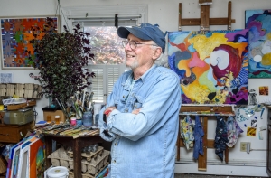 Painter Robert Gibson with his work
