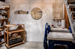 A printing press and materials for fiber and clay work.