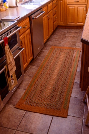 A finished rectangular rug adorns her kitchen.