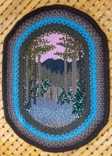 This rug was made by another woman and shows a wooded scene.
