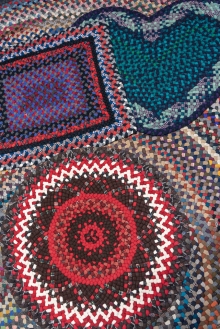 A collection of small rugs: circular, rectangular and heart-shaped.