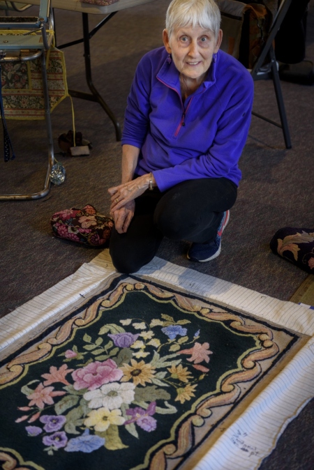 Dot Bickford, Kittery Point, shown kneeling near one of her works-in-progress.