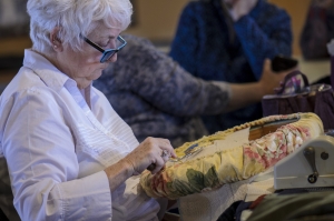 Portrait of Donna Rousseau from Wells, Maine hooking at the meeting. Donna