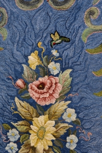 Janis Ricker signs her rugs with a small hummingbird each time.