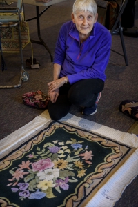Dot Bickford, Kittery Point, shown kneeling near one of her works-in-progress.