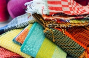 Several of Nina's new dishtowels await finishing.