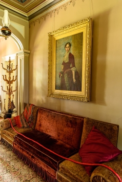 Framed paintings and old furniture grace the interior.