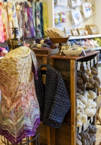 Here, a shawl, kimono jacket, yarns and painted skeins.