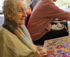 Ursula Smith working on a needlepoint.